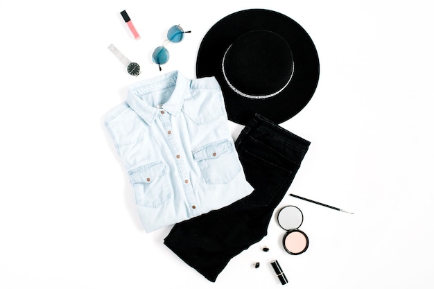 Beauty blog concept. Woman clothes and accessories: hat, jeans, t-shirt, watches, sunglasses, sneakers on white background. Flat lay, top view trendy fashion feminine background.