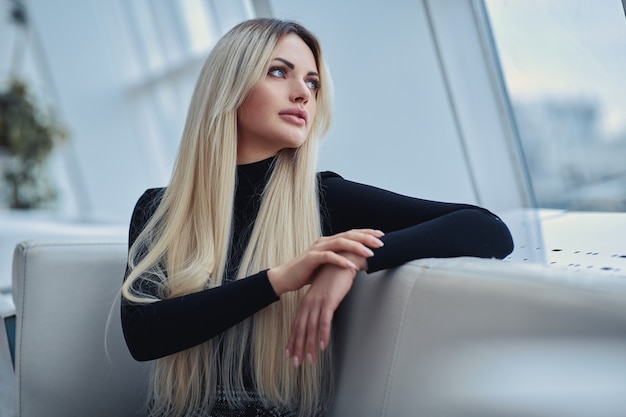 Beauty blonde girl in the cafe in style clothes