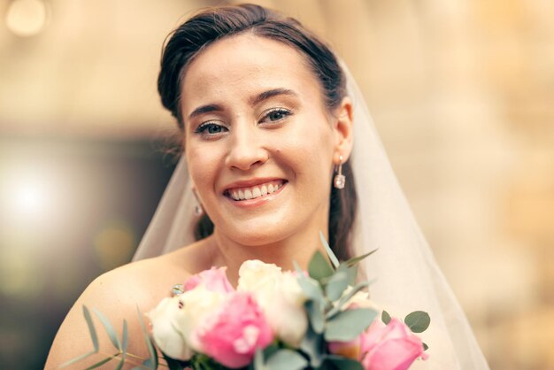 Beauty bride and portrait of a woman holding a flower bouqet on her wedding day Female beautiful and cosmetics with face of lady holding a floral bunch on her marriage day at commitment ceremony