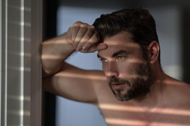 Beauty close up portrait of handsome man with moisturizing cream on face isolated background skincar