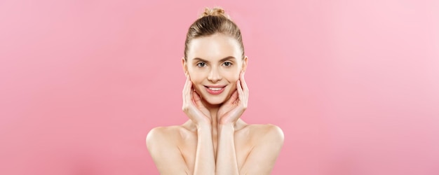 Beauty concept beautiful caucasian woman with clean skin natural makeup isolated on bright pink bac