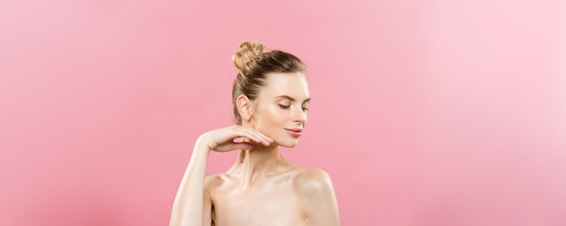 Beauty Concept Beautiful Caucasian woman with clean skin natural makeup isolated on bright pink background with copy space