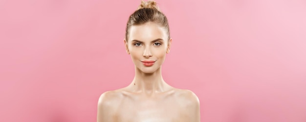 Beauty Concept Close up Portrait of attractive caucasian girl with beauty natural skin isolated on pink background with copy space