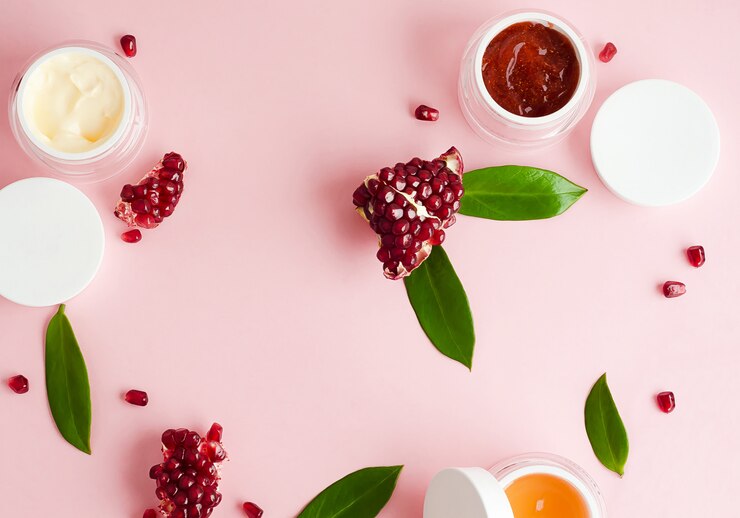 Beauty concept. natural organic cosmetics with pomegranate extract, with fruit acids, empty caps for text, logo, on pink background. flat lay, template, copy space