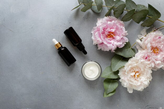 Beauty concept serum and jar with cream and eucalyptus