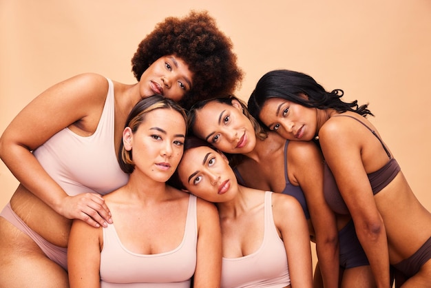 Beauty diversity and portrait of women group with makeup for cosmetic skincare isolated in studio brown background Skin body and young friends together for self care dermatology and support