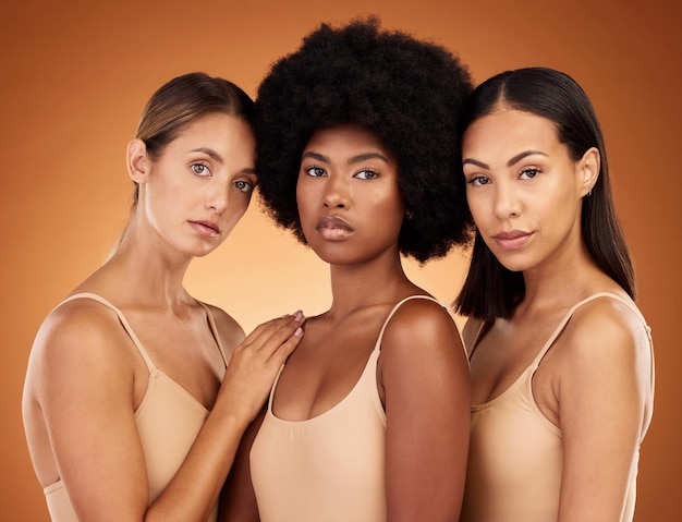 Beauty diversity and skincare with a model woman group standing in studio on a brown background to promote real Hair face and skin with a female group posing for haircare or wellness together