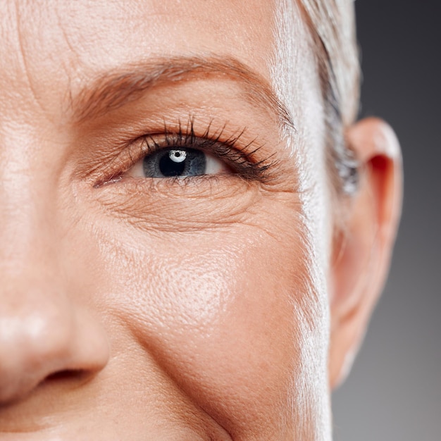 beauty eye and portrait of mature woman in studio on gray background for facial cosmetics skincare vision and wellness with confident person at salon or spa for antiaging dermatology treatment