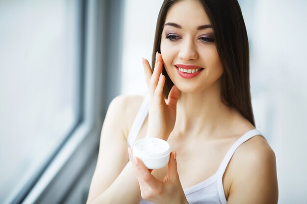 Beauty Face Care,Woman Applying Cream On Skin