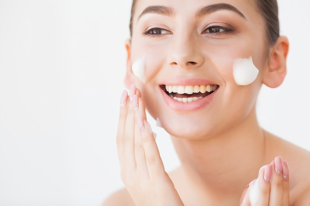 Beauty Face Care. Woman With Cream On Facial Skin