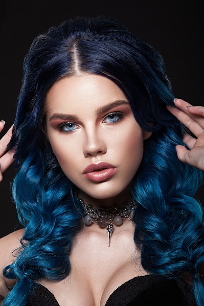 Beauty face of a girl with blue hair with a braid hair. Professional make-up, clean skin