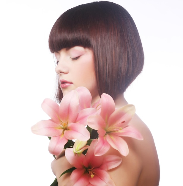 Beauty face of the young woman with pink lily