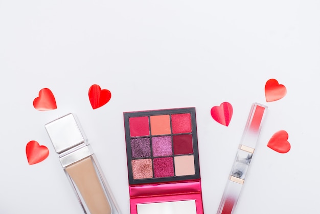 Beauty and Fashion concept.Flat lay of cosmetic and red hearts isolated