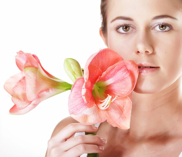 Beauty and fashion concept young beautiful woman with big pink flowers