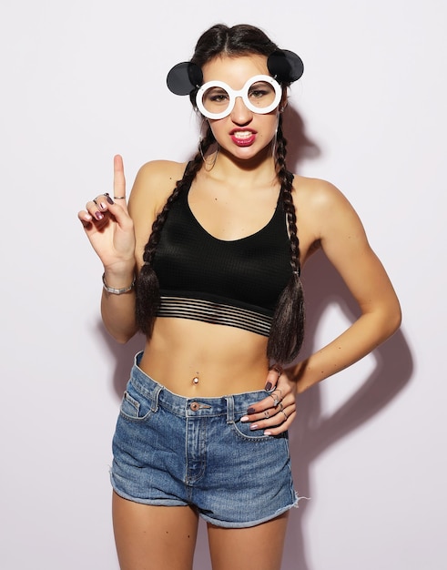 Beauty and fashion concept young woman with creative sunglasses