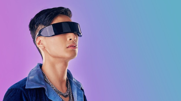 Beauty fashion and man with cyberpunk glasses in studio with blue and purple background creative cosmetics and young male model with visor for futuristic style techno and designer clothing