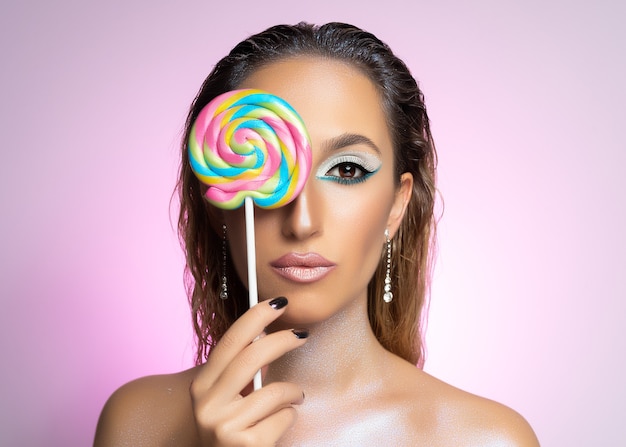 Beauty fashion model girl wiht colourful lollipop.