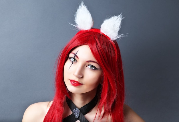 Beauty Fashion Model Girl with red wig on gray background