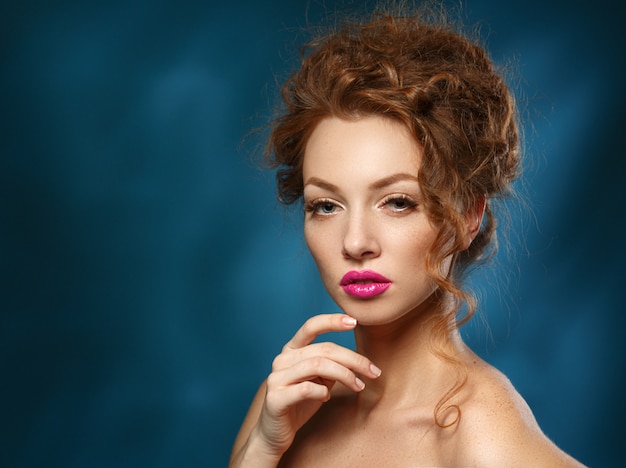 Beauty Fashion Model woman with Curly Red Hair, Long Eyelashes. Beautiful Stylish Woman with Healthy Smooth Skin.