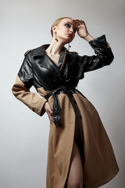 beauty fashion young woman in trench coat, professional face makeup girl. portrait of woman on white background. spring clothing in rainy weather