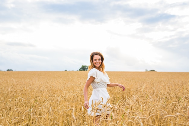 Beauty Girl Outdoors enjoying nature on the Field.