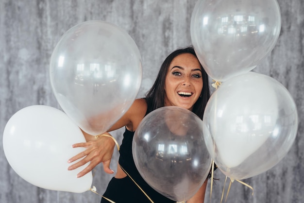 Beauty girl with air balloons smiling Celebrating Holiday