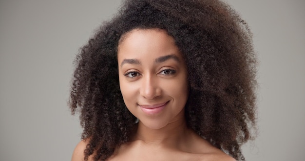 beauty and healthcare beautiful african american woman with curly afro hairstyle and clean healthy