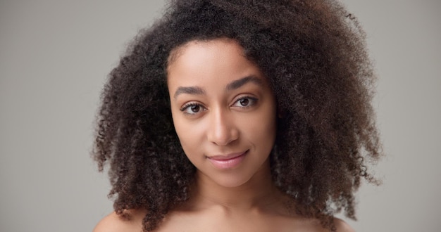 beauty and healthcare concept beautiful african american woman with curly afro hairstyle and clean