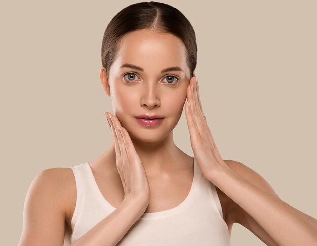 Beauty healthy skin woman touching her face beautiful female. Color background. Brown