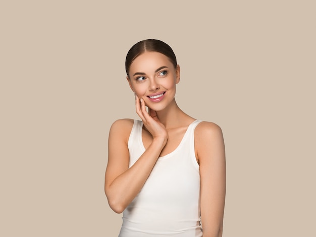 Beauty healthy skin women touching face cosmetic studio portrait. Sportswear color background brown
