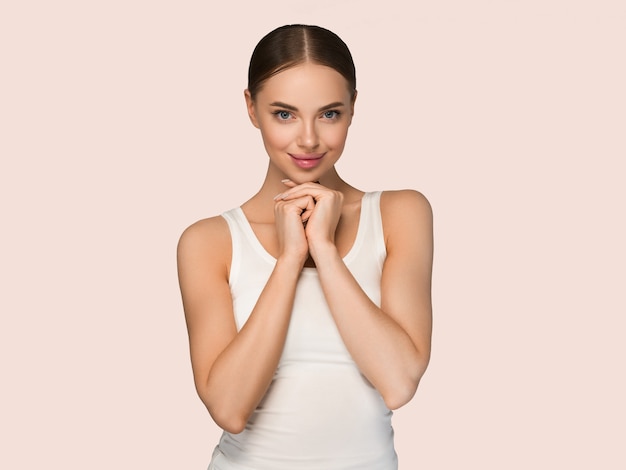 Beauty healthy skin women touching face cosmetic studio portrait. Sportswear color background yellow