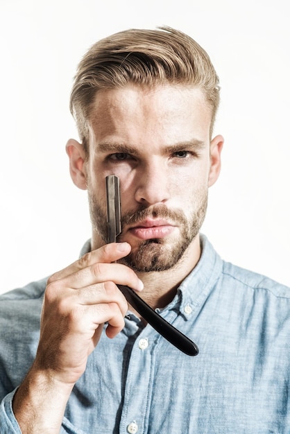 Beauty industry and home skin care concept bearded man having shave with razor blade portrait of man