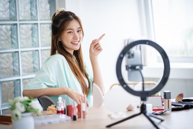 Beauty influencer Aziatisch meisje make-up artist mooie vrouw die naar de camera kijkt live streaming