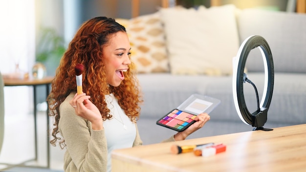 Photo beauty influencer filming a makeup tutorial at home young female blogger live streaming a broadcast online with ring light for a vlog channel recording a fun podcast for followers on social media