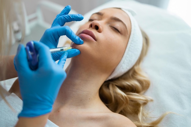 Beauty injections in chin. Woman getting face lifting procedure