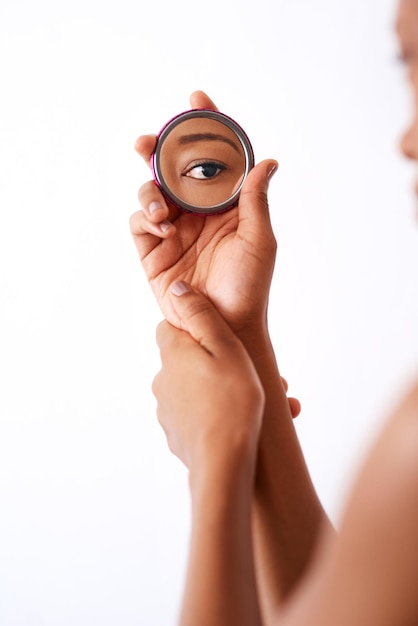 Beauty is in the eye of the beholder Studio shot of an unrecognizable woman holding a pocket size mirror against a white background