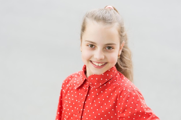 Beauty is happiness Little child with cute smile on beauty face and blonde hair Happy beauty girl smiling on summer day Beauty look of adorable small girl outdoor