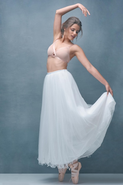 Beauty is nothing without grace Shot of a beautiful young woman posing in studio while wearing a bra and ballet skirt