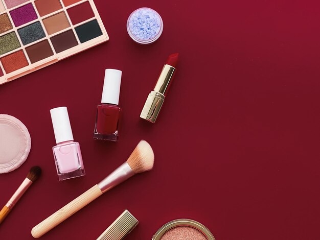 Beauty makeup and cosmetics flatlay design with copyspace
cosmetic products and makeup tools on burgundy background girly and
feminine style concept