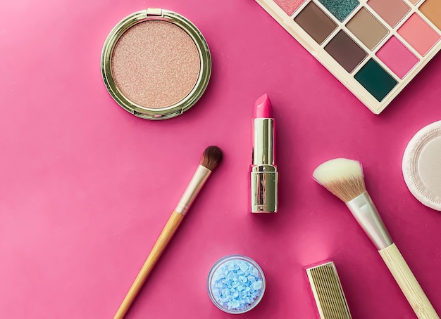 Beauty makeup and cosmetics flatlay design with copyspace cosmetic products and makeup tools on pink background girly and feminine style concept