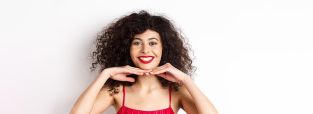 Beauty and makeup pretty lady with curly hair red lips and white teeth smiling and showing perfect f