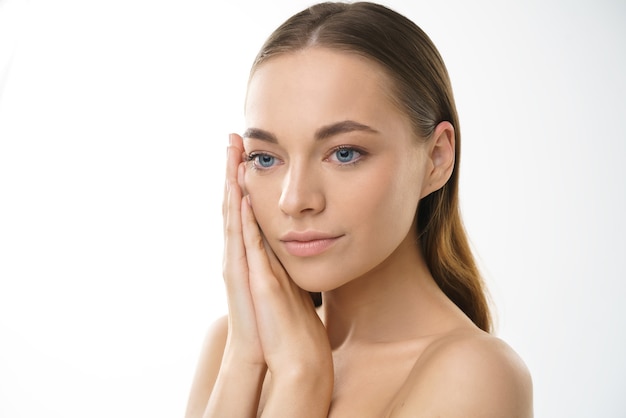 Beauty model young blonde woman with blue eyes with natural make-up and healthy skin on a white background