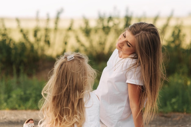 Beauty Mum and her Child playing in Park together Outdoor Portrait of happy family