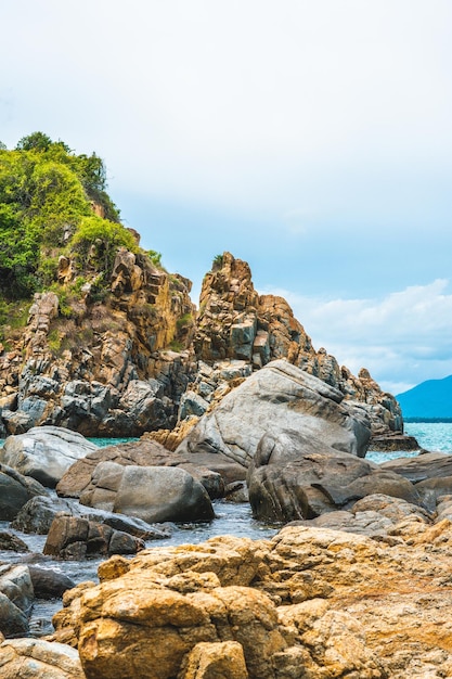 Beauty panorama edged shabby sea cliff cumulus cloud sky
mountain island background gray brown stone rock texture vivid
colour photo concept of geology tourism after pandemic power in
nature