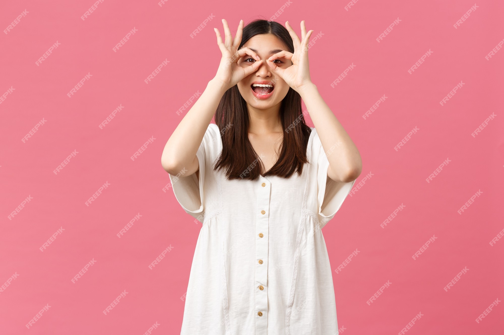 Premium Photo | Beauty, people emotions and summer leisure concept. playful gorgeous funny asian girl in white dress, make fake glasses from hands and looking through it at super cool promo, smiling Premium Photo | Beauty, people emotions and summer leisure concept. playful gorgeous funny asian girl in white dress, make fake glasses from hands and looking through it at super cool promo, smiling