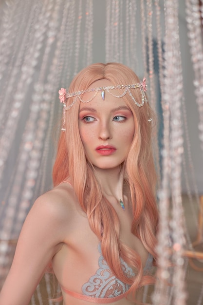 Beauty portrait of anime princess elf woman with pink hair in underwear Fabulous magical look beautiful pink makeup Rim crown on the head of a woman