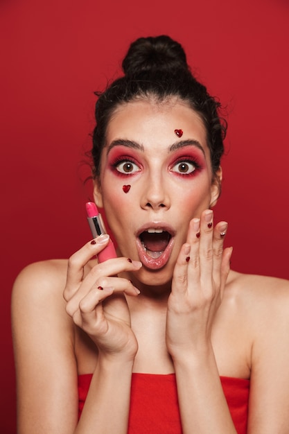 Beauty portrait of an attractive young topless woman wearing makeup standing isolated 