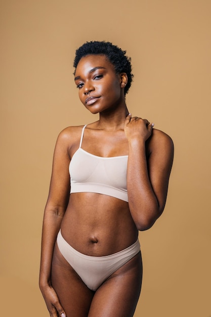 Premium Photo  Minimal waist up portrait of confident black woman wearing  underwear and posing with hands on hips a