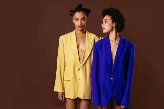 Beauty portrait of beautiful black women wearing lingerie underwear and colored blazers pretty african young women posing in studio concepts about beauty cosmetology and diversity