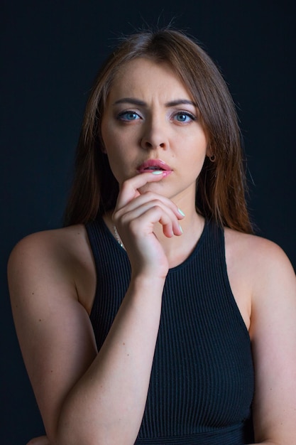 Beauty Portrait of Beautiful Woman on Black Background. Woman Portrait With Finger on Lips